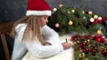 Little girl writes a letter to santa claus. Emotions: joy, happiness, thoughtfulness, fatigue... Christmas should be hurried soon