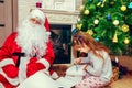 Little girl writes a letter to Santa. Royalty Free Stock Photo