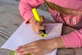 Little girl writes in a notebook on the nature Royalty Free Stock Photo