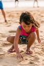 Little girl writing on the beach sand Royalty Free Stock Photo