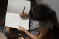 Little girl writing book and having cookie at stairway at home Royalty Free Stock Photo