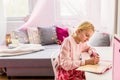 Little girl writing diary