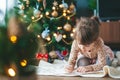 Little girl writing a letter to Santa Claus Royalty Free Stock Photo