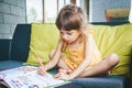 Little girl writing numbers in the study book