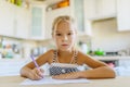 Little girl writing with pen in notebook Royalty Free Stock Photo