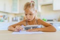 Little girl writing with pen in notebook Royalty Free Stock Photo