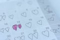 Little girl written heart thumbtack in date of February 14 Valentine.