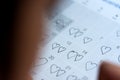 Little girl written heart thumbtack in date of February 14 Valentine.