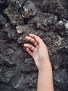 a little girl& x27;s hand stuck to a natural stone wall Royalty Free Stock Photo