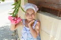 Little girl 5 years blonde smelling a flower in the summer