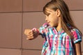 Little girl of 6 7 years looking at smart watch to to see who does calling Royalty Free Stock Photo