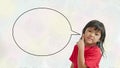 Little girl, 4 years old, being happy while pointing her finger up, with a blank speech bubble on a white milky oil-painting Royalty Free Stock Photo