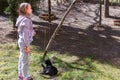 Little girl playing in the backyard with a black cat Royalty Free Stock Photo
