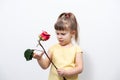 Little girl in a yellow blouse with faded flowers