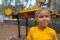 Little girl in yellow blouse on the playground Royalty Free Stock Photo