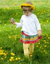 Little girl in yellow chaplet playing Royalty Free Stock Photo