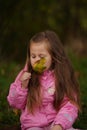 Little girl with yellow leaf. Child playing with autumn golden leaves. Kids play outdoors in the park. Children hiking Royalty Free Stock Photo