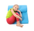 Little girl with yoga mat on white background