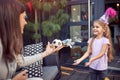 Little girl and young female adult playing with a small ball at birthday party