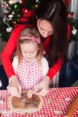 Little girl with young mother baking Christmas Royalty Free Stock Photo