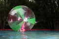 Little girl in Zorb in the pool