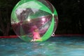 Little girl in Zorb in the pool