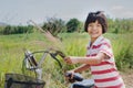 Little girle with bicycle in countryside