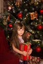 Little girle with christmass gift in her hands