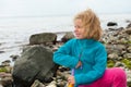 Little girlon ston beach is looking to the sea