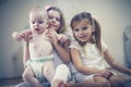 Little girls with baby brother poses to camera. Royalty Free Stock Photo