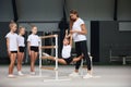 Little girls, beginner gymnastics athletes doing exercises with gymnastics equipment at sports gym, indoors. Concept of Royalty Free Stock Photo