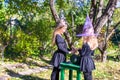 Little girls casting a spell on Halloween in witch