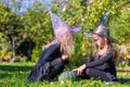 Little girls casting a spell on Halloween in witch