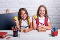 Little girls in classroom at knowledge day. School time of girls. Happy school kids at lesson. Back to school and home Royalty Free Stock Photo