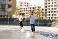 Little girls cool off in a fountain on a hot summer day.