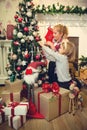 Little girls decorating Christmas tree and preparing gifts