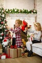 Little girls decorating Christmas tree and preparing gifts