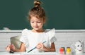 Little girls drawing a colorful pictures with pencil crayons in school classroom. Painting kids. Childhood learning Royalty Free Stock Photo