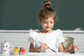 Little girls drawing a colorful pictures with pencil crayons in school classroom. Painting kids. Childhood learning Royalty Free Stock Photo