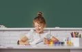 Little girls drawing a colorful pictures with pencil crayons in school classroom. Painting kids. Cute school girl