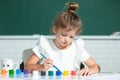 Little girls drawing a colorful pictures with pencil crayons in school classroom. Painting kids. Early childhood