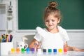 Little girls drawing a colorful pictures with pencil crayons in school classroom. Painting kids. Little funny artist