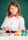 Little girls drawing a colorful pictures with pencil crayons in school classroom. Painting kids. Portrait of little girl