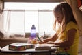 Little girls drawing in train travelling with family, Russia