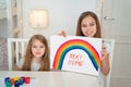Little girls write stay home. flashmob. rainbow