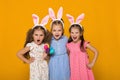 Little girls with Easter bunny ears holding colorful eggs Royalty Free Stock Photo