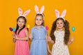 Little girls with Easter bunny ears holding colorful eggs Royalty Free Stock Photo