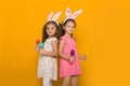 Little girls with Easter bunny ears holding colorful eggs Royalty Free Stock Photo