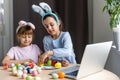little girls for easter paint eggs, record lessons on web camera with laptop