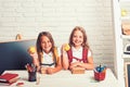 Little girls eat apple at lunch break. Friendship of small sisters in classroom at knowledge day. School time of girls Royalty Free Stock Photo